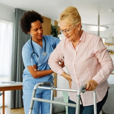 caregiver assisting the elderly woman