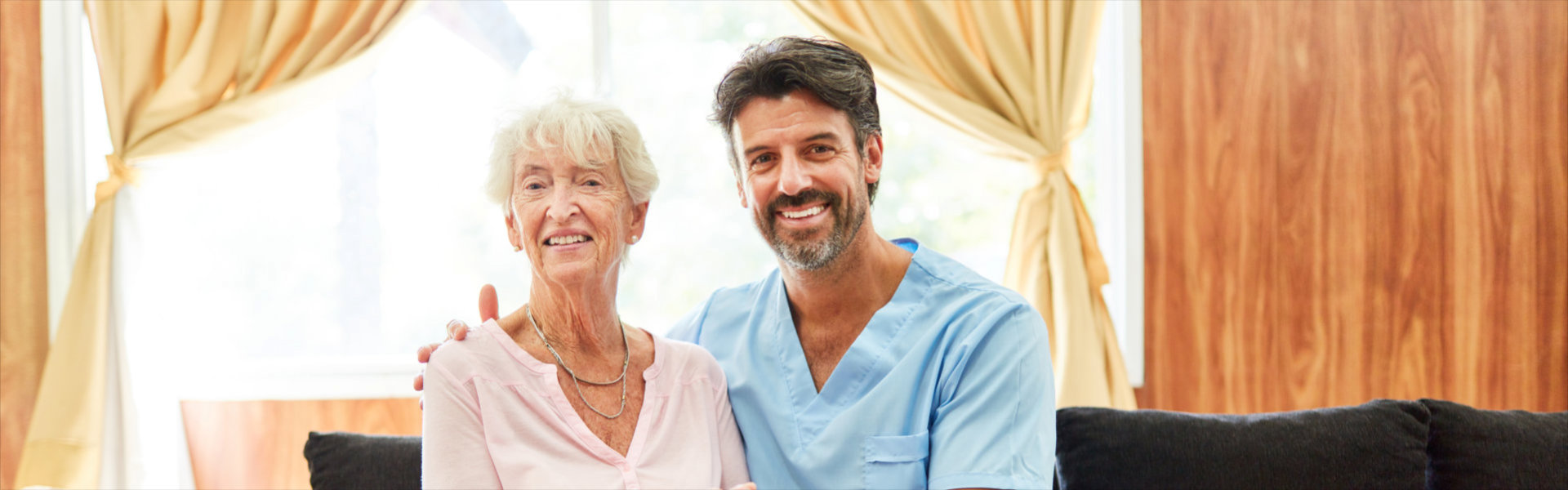 caregiver and elderly smiling